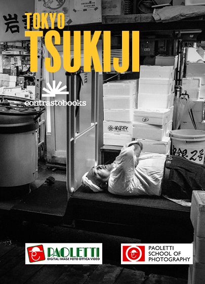 Official poster of the exhibition dedicated to Tokyo Tsukiji by Nicola Tanzini that will be held in Bologna at Paoletti Foto, Galleria Cavour. The photo represents a worker of the market sleeping on a cart at the end of the working day.