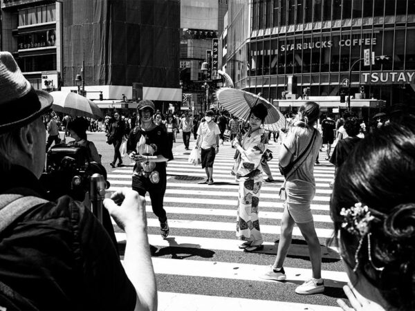 Photo #98 Tokyo, 2019: woman standing on the crosswalk